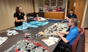 3 people making blankets
