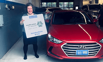 Auto Aves customer standing next to their newly purchased Red Hyundai