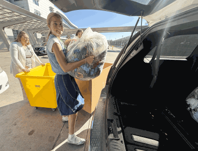 CUD employee grabbing blankets for Children's Hospital