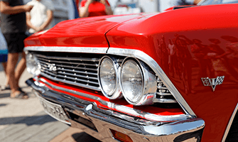Close-up of a Classic red car front headlights