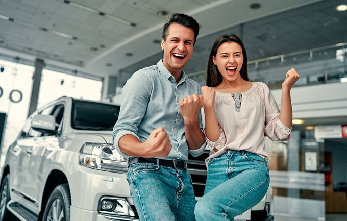 Couple celebrates new car purchase