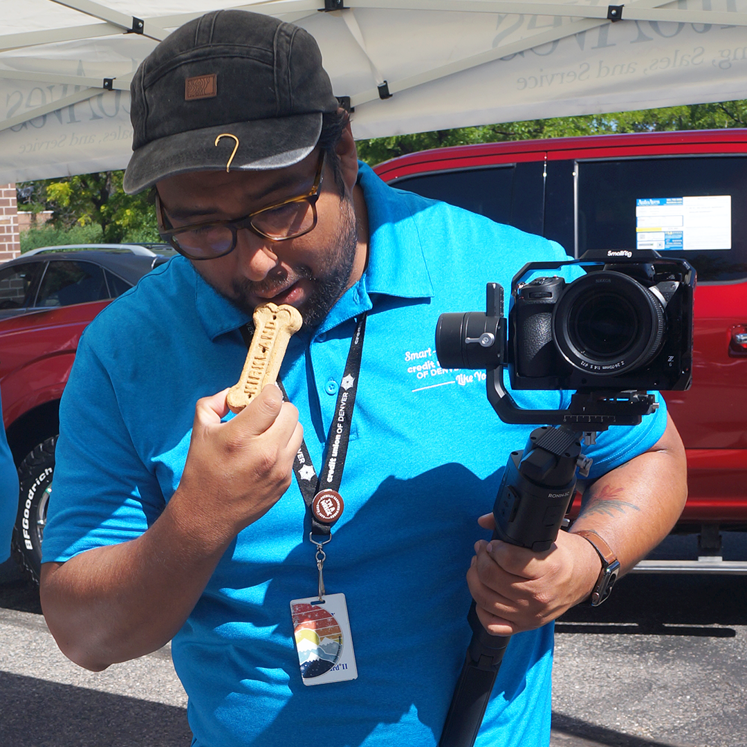 CUD employee pretending to eat a dog biscuit