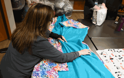 Volunteer working on no sew blankets