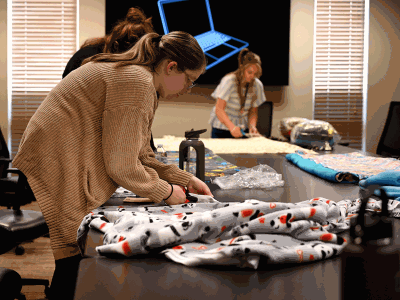 Volunteers working on no sew blankets