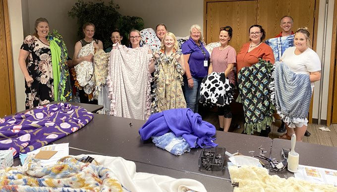 group of people holding blankets