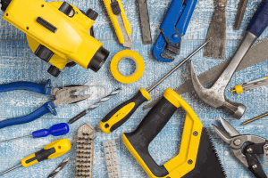 Tools for home improvements laid out on a blue deck.