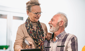 Elderly man and woman smiling at each other