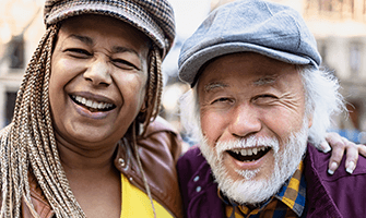 Smiling African American and Asian older couple.