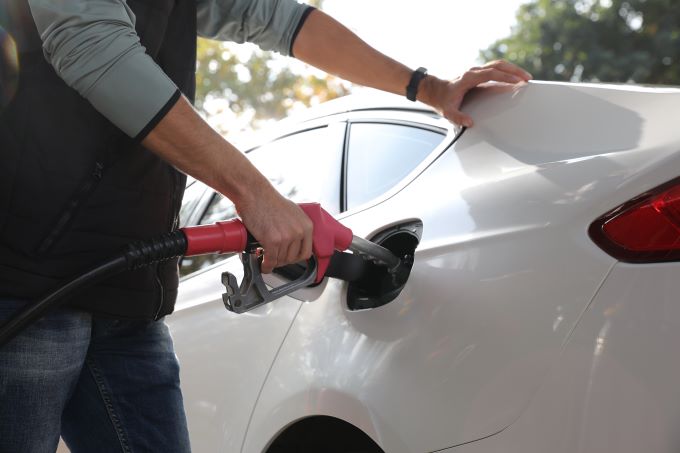 man putting gas in his car