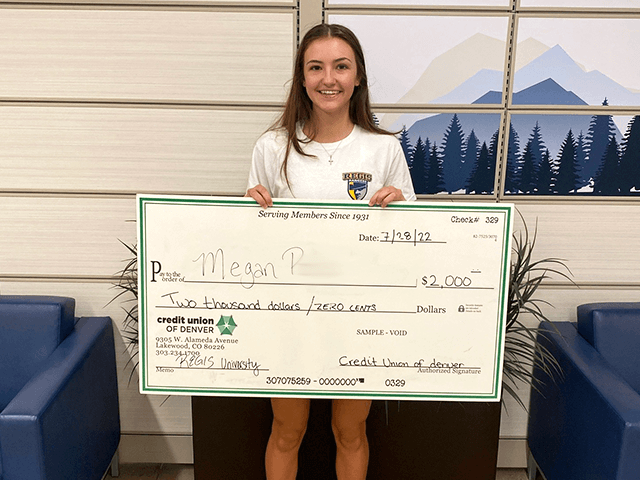 Megan P. 2022 C·U·D Scholarship Winner holding giant check