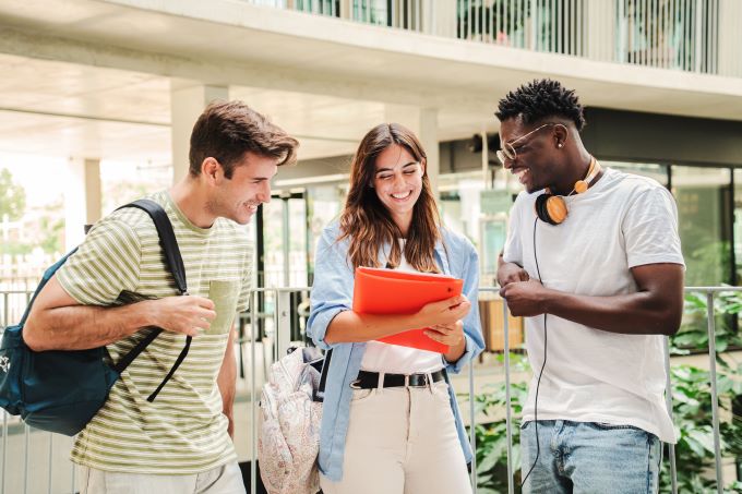 group of students smiling in hallway