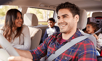 Hispanic family driving in their car together