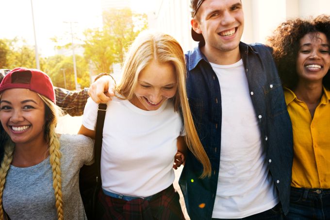 Smiling young adults walking together