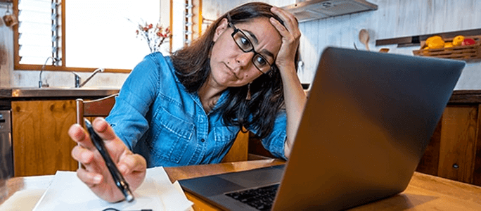 Stressed woman working on a laptop