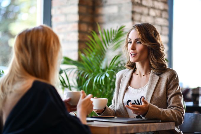 two young business woman get coffee