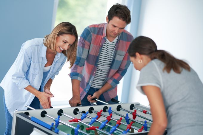 College students playing foosball