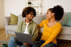 couple using laptop to search for deals