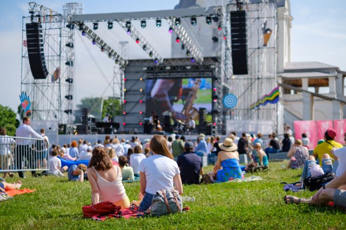 people sitting festival crowd