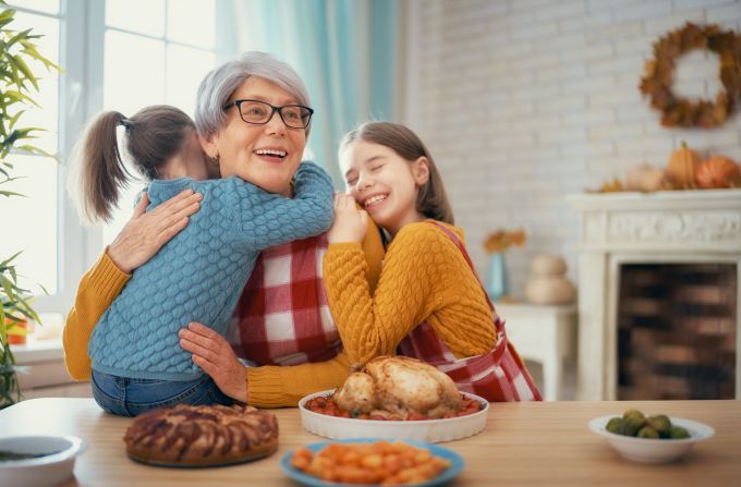 grandma hugging grand daughters at Thanksgiving