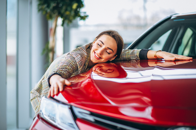 woman hugs her car