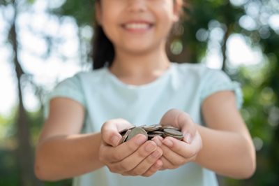 Little Girl Holding Coins