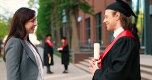 Mom smiling at graduating son