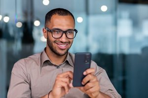 Man smiling at his phone
